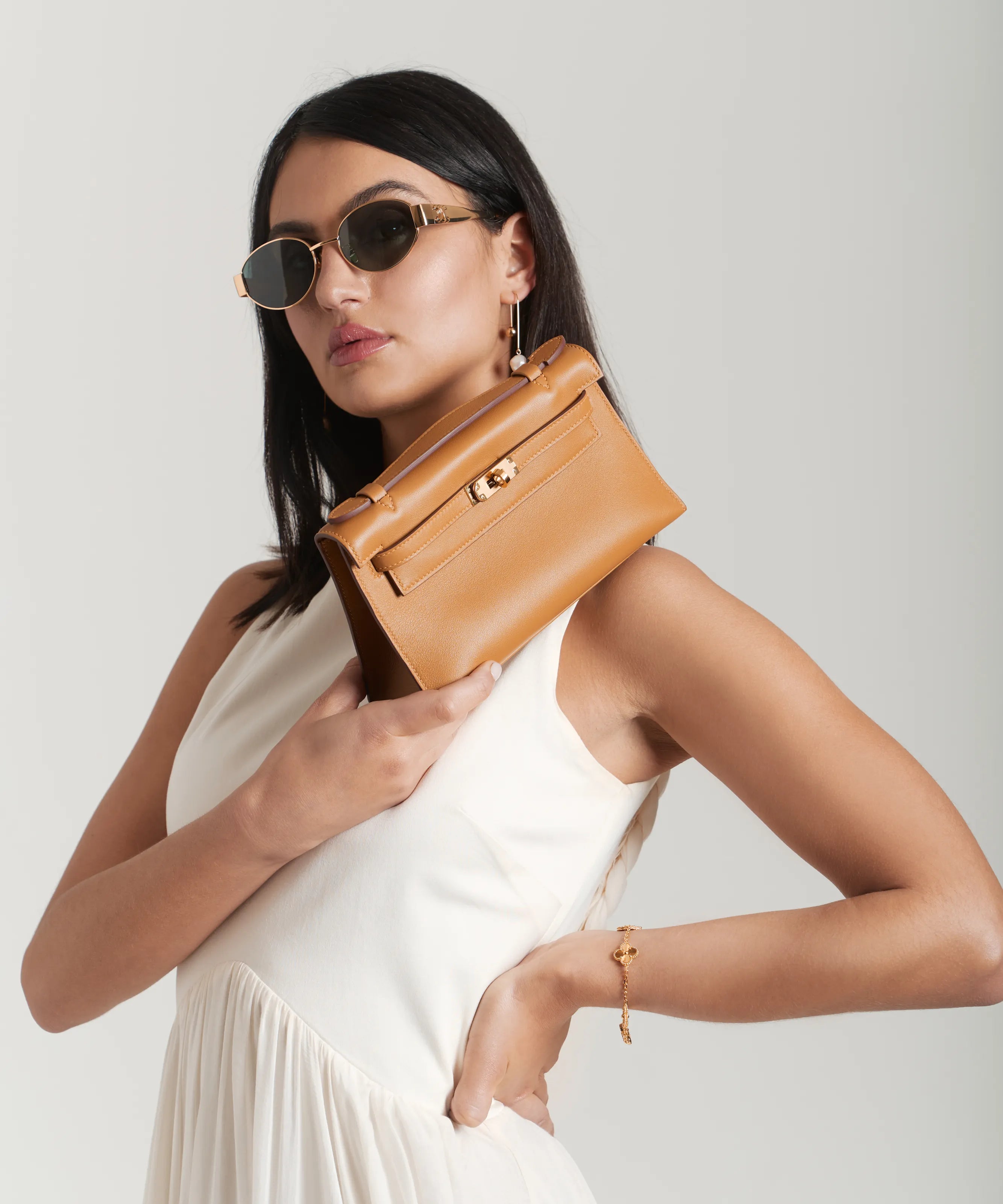 Hermès Kelly Pochette bag in Chai styled with summer accessories