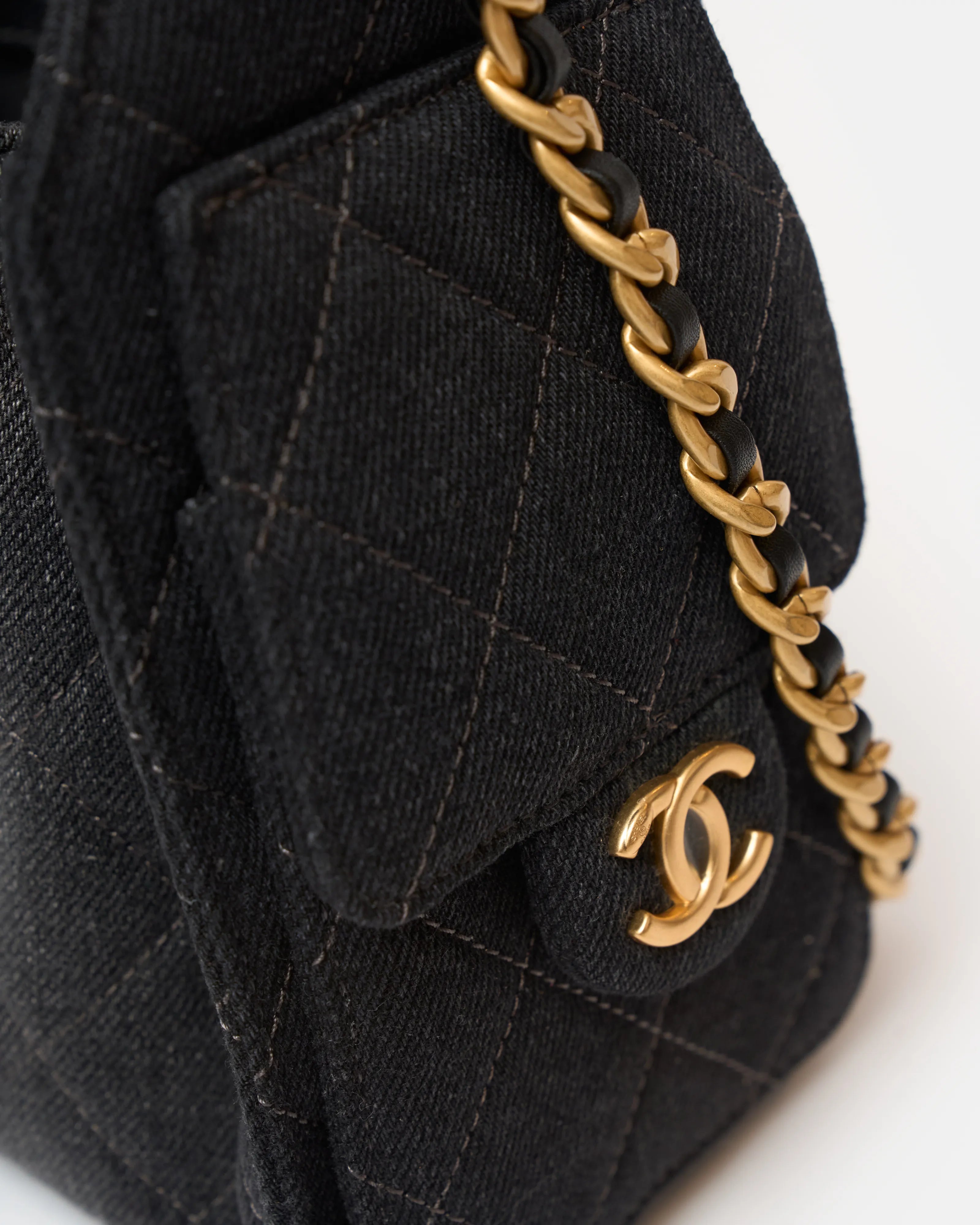 Chanel 25 shoulder bag in black color and washed denim material in GHW 