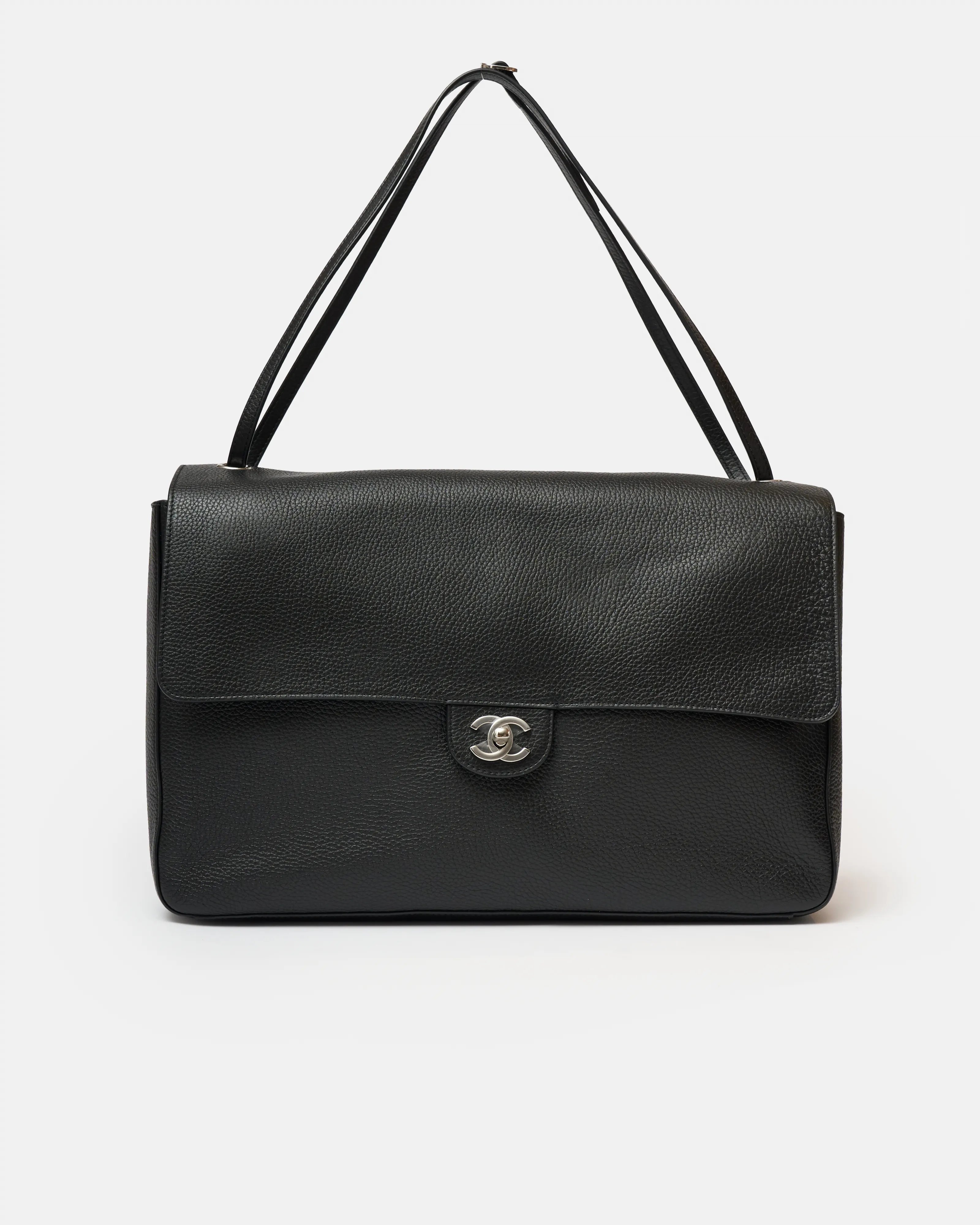 Chanel maxi flap shoulder bag in black color and grained calfskin material in PHW 