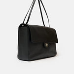 Chanel maxi flap shoulder bag in black color and grained calfskin material in PHW 