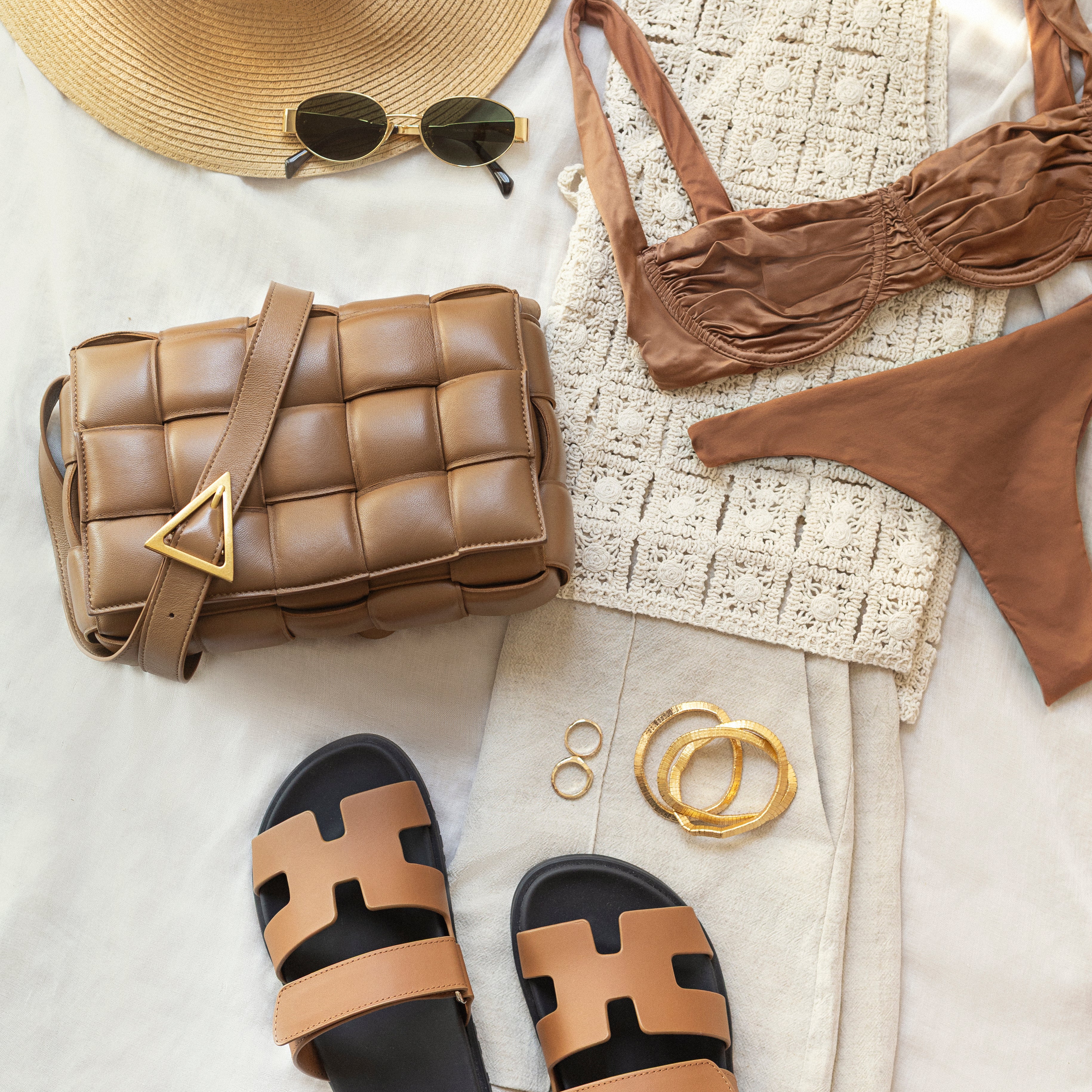 Bottega Veneta Padded Cassette bag in Caramel styled with Hermès sandals and summer accessories