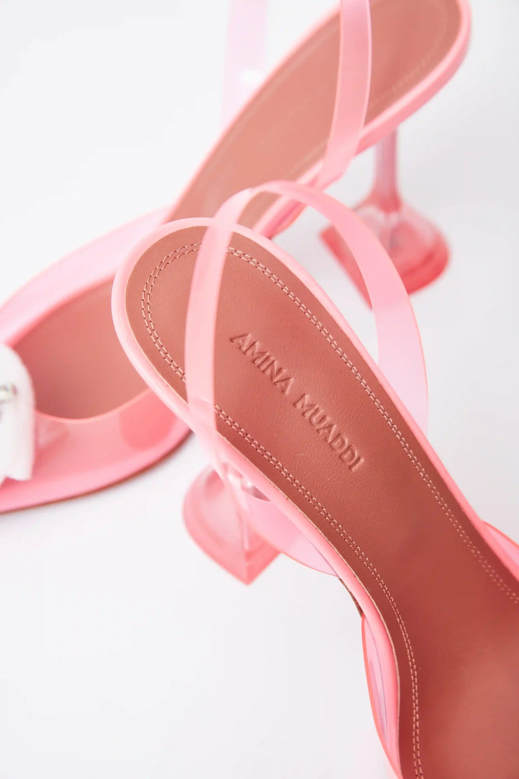 Amina Muaddi Rosie Glass PVC pink transparent slingback pumps with crystal buckle detail