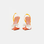 Amina Muaddi Rosie Glass PVC orange transparent slingback heels with crystal bow detail