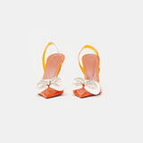 Amina Muaddi Rosie Glass PVC orange transparent slingback heels with crystal bow detail