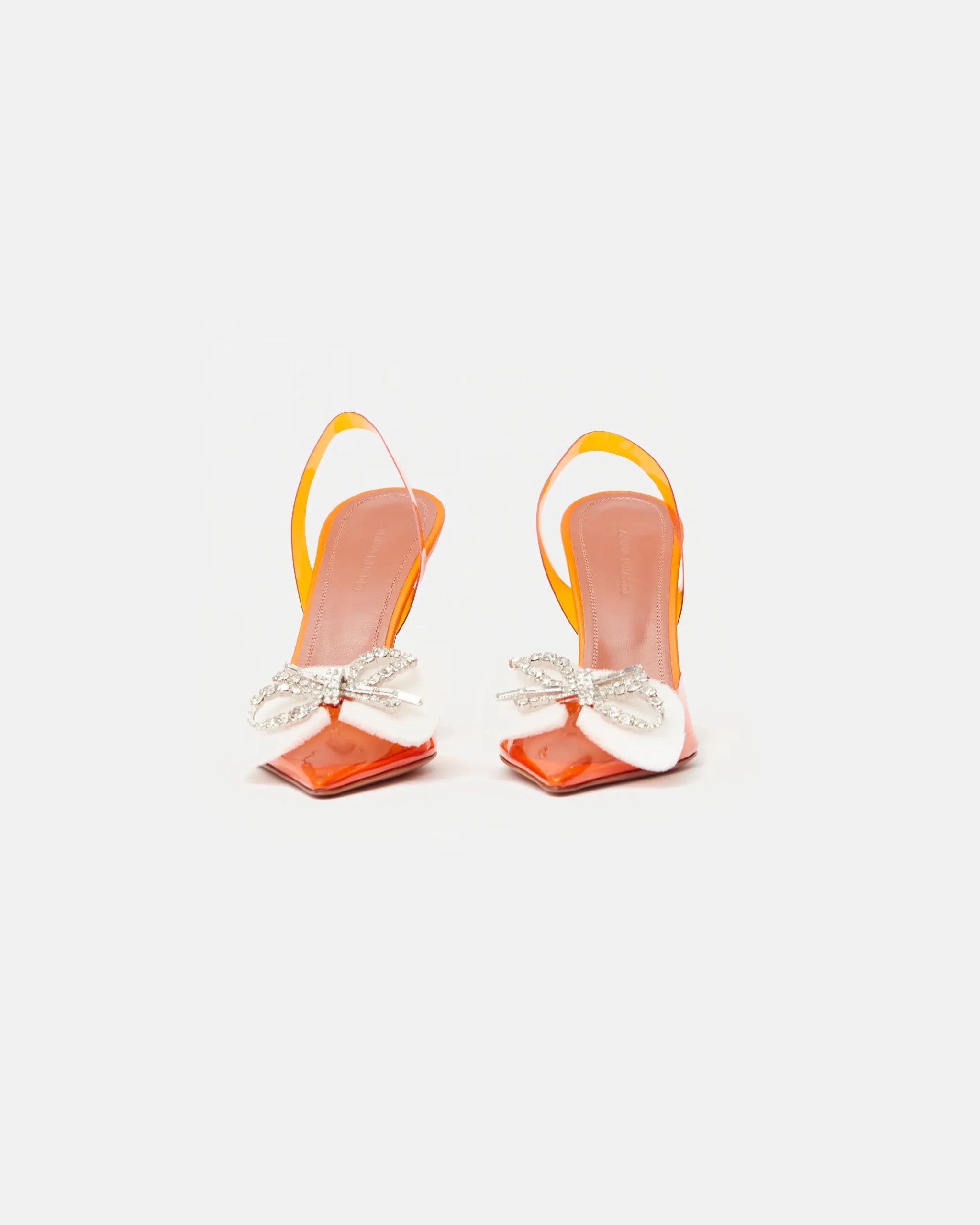 Amina Muaddi Rosie Glass PVC orange transparent slingback heels with crystal bow detail