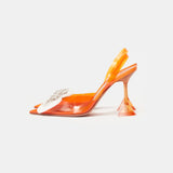 Amina Muaddi Rosie Glass PVC orange transparent slingback heels with crystal bow detail