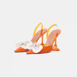 Amina Muaddi Rosie Glass PVC orange transparent slingback heels with crystal bow detail