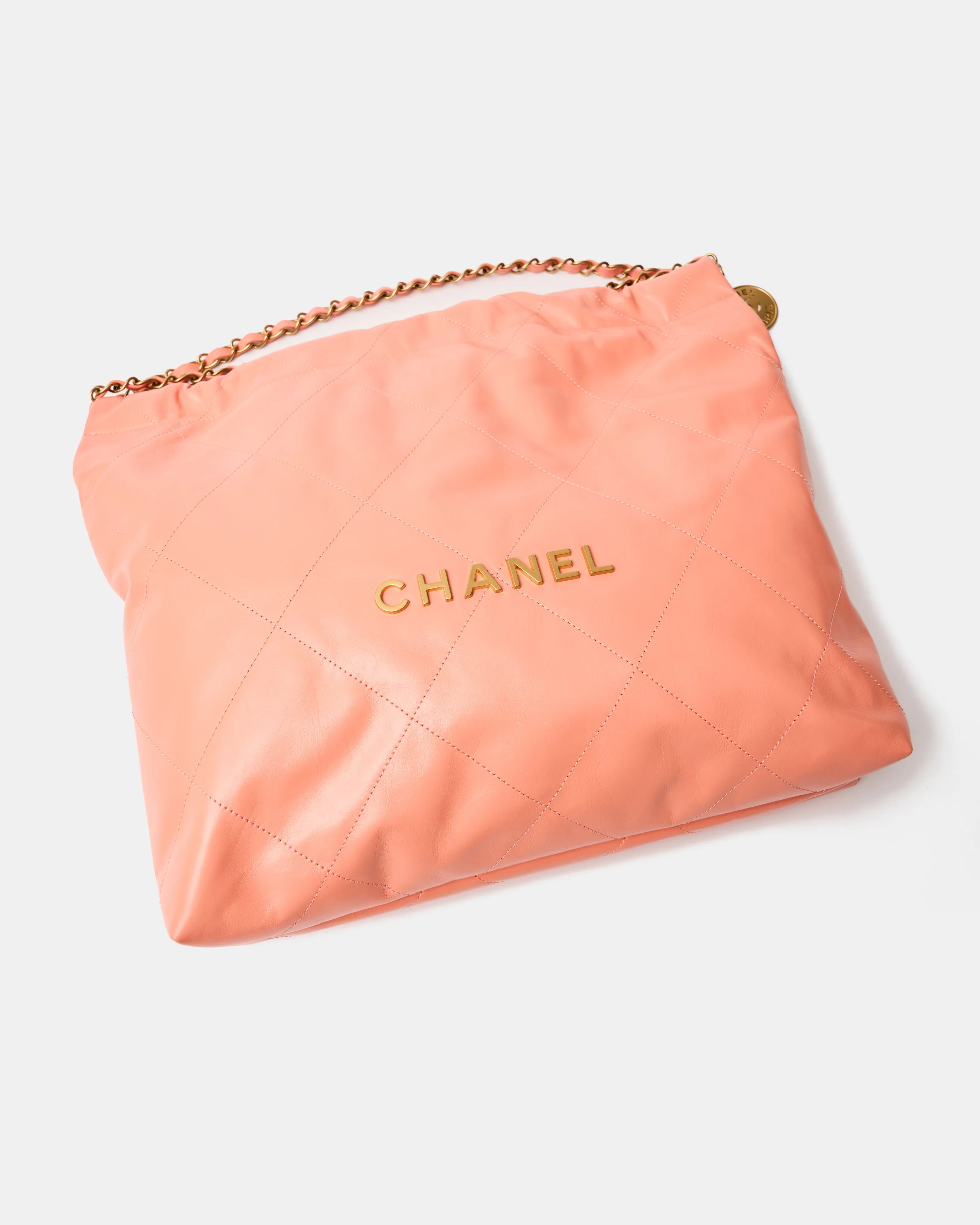 Chanel 22 Handbag in light orange color and Shiny Calfskin leather in GHW 
