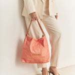 Chanel 22 Handbag in light orange color and Shiny Calfskin leather in GHW 