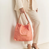 Chanel 22 Handbag in light orange color and Shiny Calfskin leather in GHW 