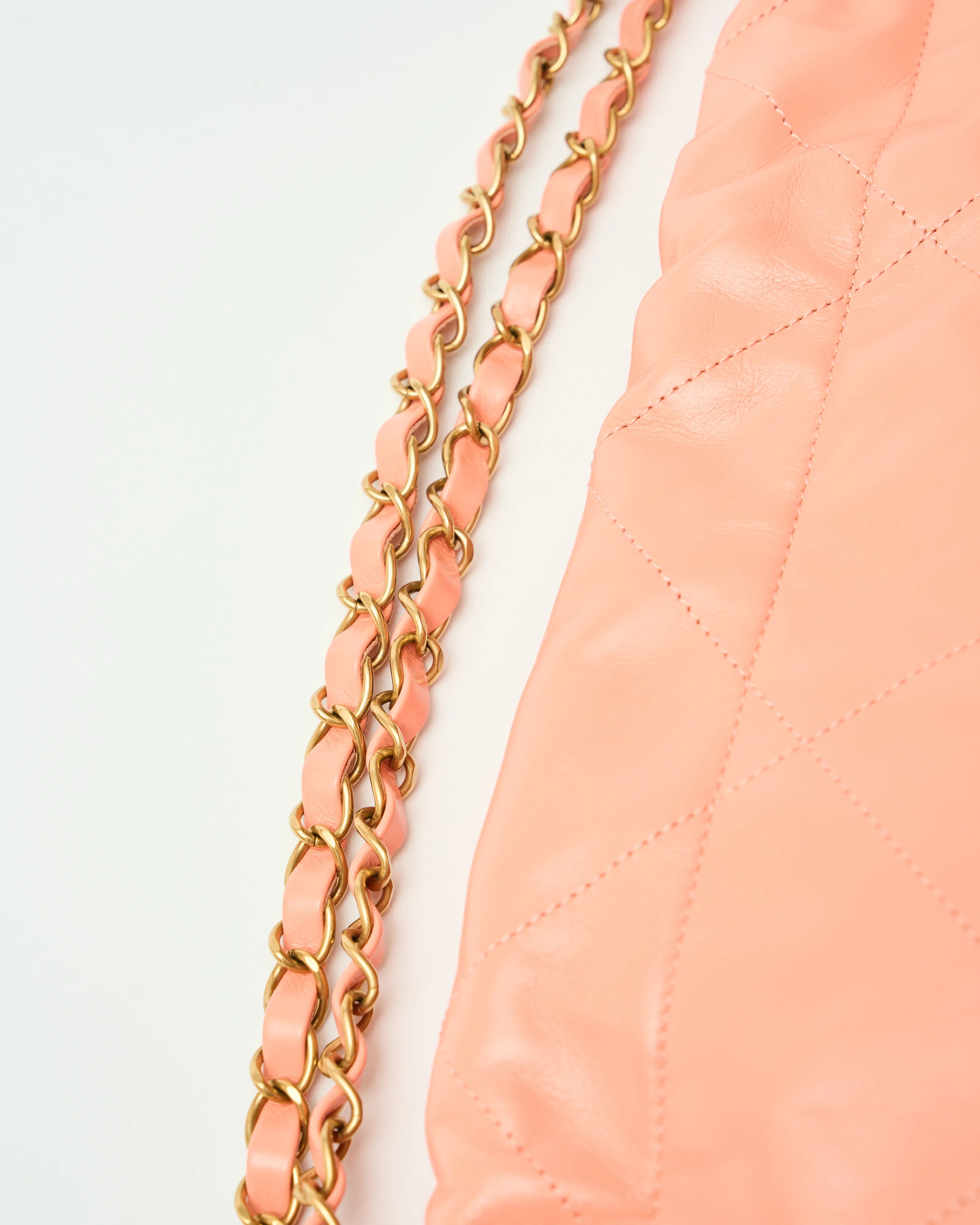 Chanel 22 Handbag in light orange color and Shiny Calfskin leather in GHW 