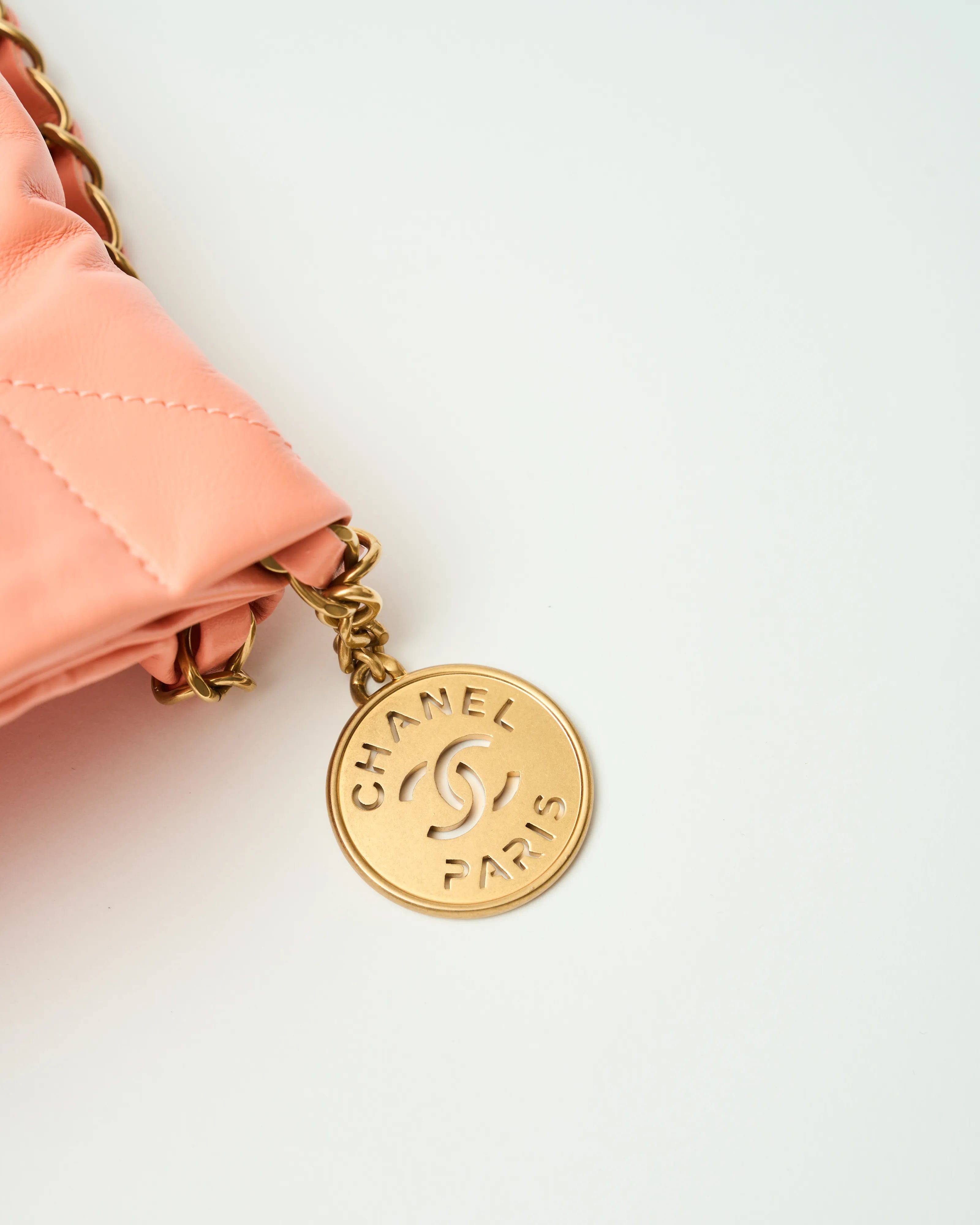 Chanel 22 Handbag in light orange color and Shiny Calfskin leather in GHW 